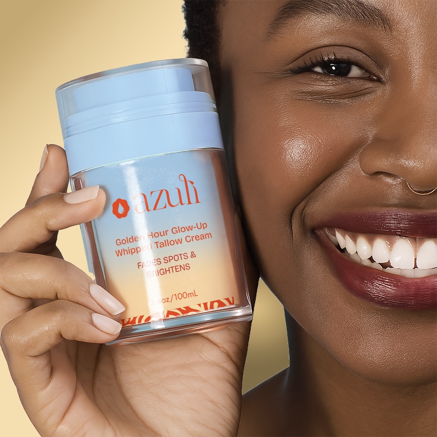 A model smiling beside a Golden Hour Glow-Up jar